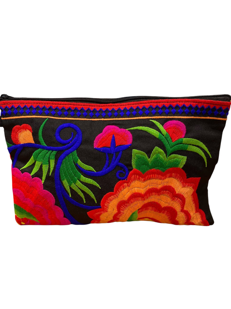 Ruby red and tangerine bloom on licorice clutch