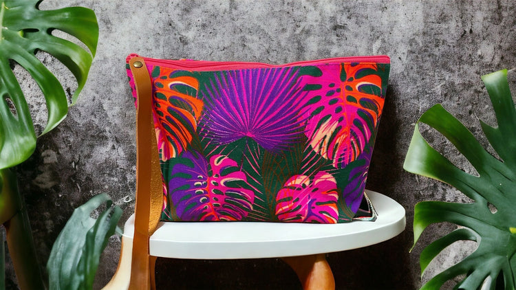 Neon monsteria on forest green clutch