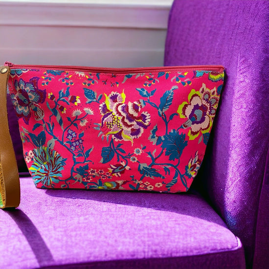 Multi blue florals on neon pink clutch