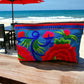 Ruby red bloom on marine blue clutch